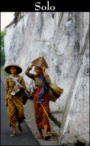 Two women outside of the walls for Kraton Surakarta