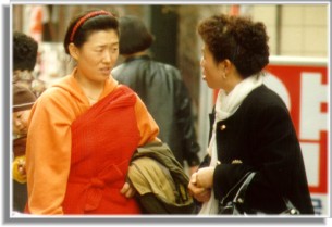 Two Women Conversing During Their Shopping